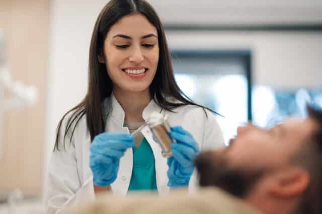A happy patient with a beautiful and natural-looking smile after completing a full treatment for dental veneers in Istanbul at Esnan Clinic.